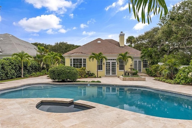 201 Sundial Ct, Vero Beach, FL 32963 - swimming pool with french doors, a patio area, and an in-ground hot tub