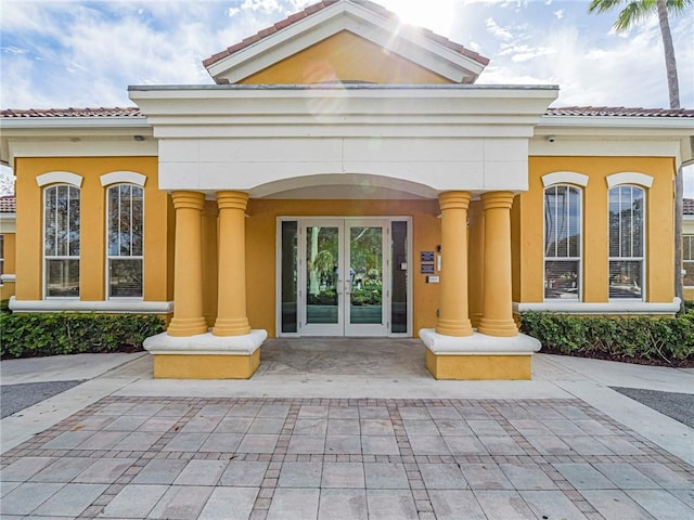 5095 Fairways Cir Unit I203, Vero Beach, FL 32967 - doorway to property featuring french doors, a tiled roof, and stucco siding