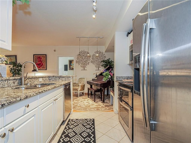5095 Fairways Cir Unit I203, Vero Beach, FL 32967 - kitchen featuring stainless steel appliances, white cabinets, light tile patterned floors, and light stone countertops