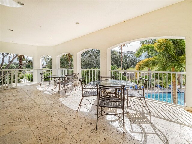 5095 Fairways Cir Unit I203, Vero Beach, FL 32967 - view of patio featuring an outdoor pool and outdoor dining space