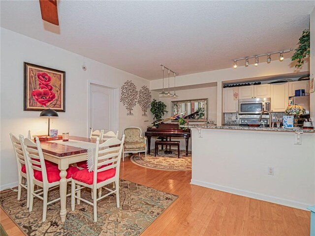 5095 Fairways Cir Unit I203, Vero Beach, FL 32967 - dining area featuring light wood-type flooring and a textured ceiling
