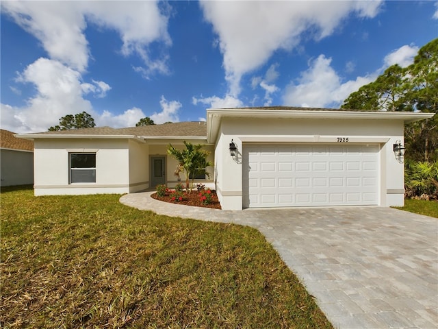 single story home featuring a garage and a front yard