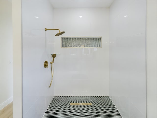 bathroom with tiled shower