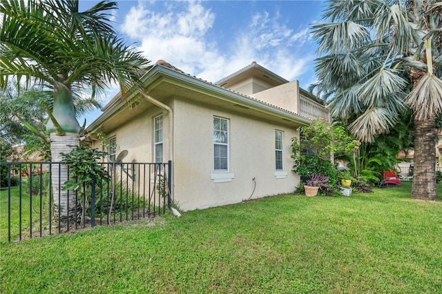 view of side of home with a lawn