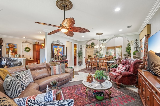 living room featuring ornamental molding, ceiling fan with notable chandelier, and light tile patterned flooring