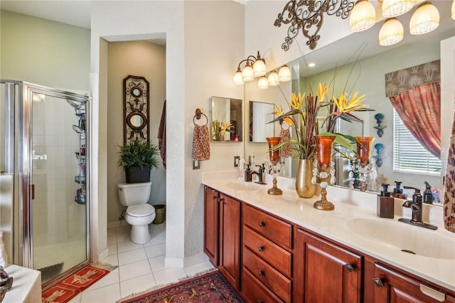 bedroom with ornamental molding, connected bathroom, hardwood / wood-style flooring, a tray ceiling, and ceiling fan