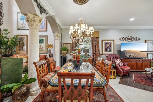 dining space with ornamental molding, a notable chandelier, light tile patterned flooring, and decorative columns