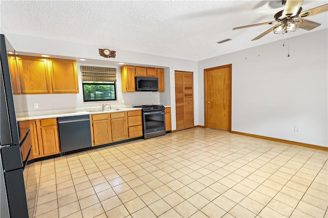 930 47th Ave SW, Vero Beach, FL 32968 - kitchen with dishwasher, range with gas stovetop, black microwave, a sink, and light countertops
