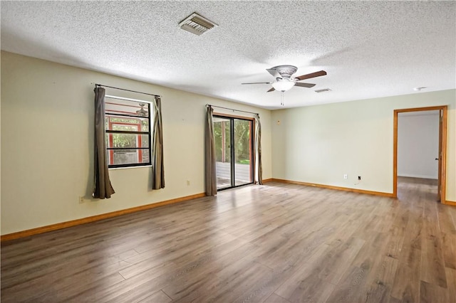930 47th Ave SW, Vero Beach, FL 32968 - empty room with wood finished floors, a ceiling fan, baseboards, and a textured ceiling