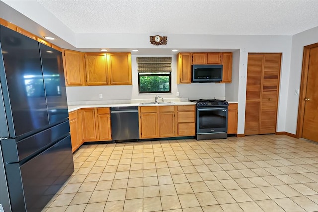 930 47th Ave SW, Vero Beach, FL 32968 - kitchen with black appliances, a sink, light countertops, a textured ceiling, and recessed lighting