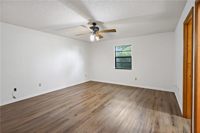 930 47th Ave SW, Vero Beach, FL 32968 - unfurnished bedroom with wood finished floors, a textured ceiling, a ceiling fan, and baseboards