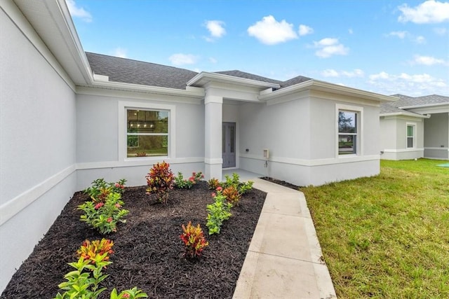 property entrance featuring a lawn