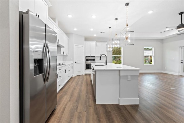 kitchen featuring sink, stainless steel appliances, dark hardwood / wood-style flooring, a center island with sink, and white cabinets