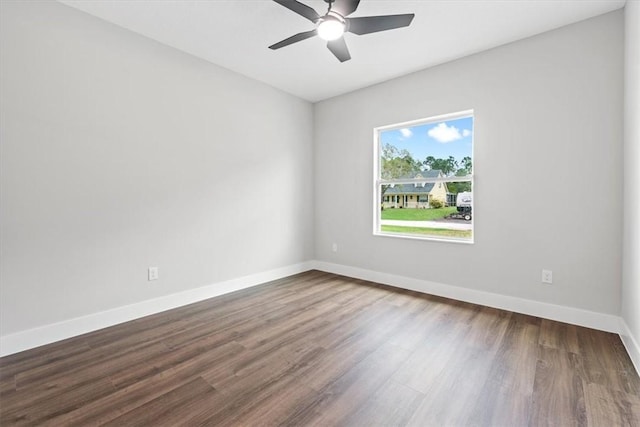 empty room with dark hardwood / wood-style floors and ceiling fan