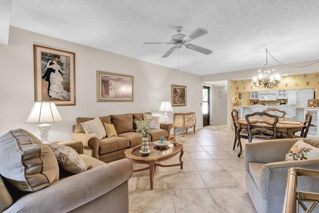 living room featuring ceiling fan with notable chandelier and a textured ceiling