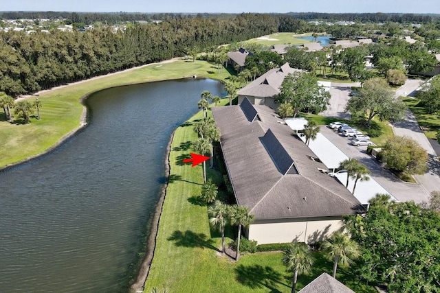 drone / aerial view with a water view and golf course view