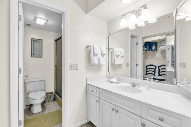 bathroom featuring visible vents, toilet, vanity, tile patterned floors, and a shower with shower door
