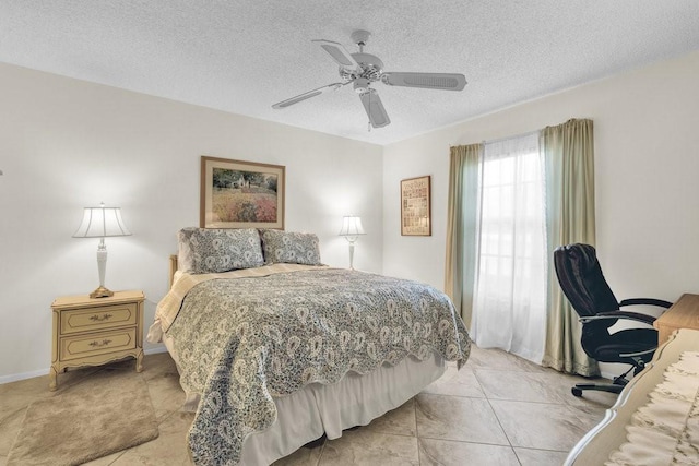 bedroom with a textured ceiling, ceiling fan, and baseboards