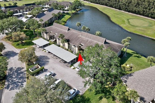birds eye view of property with a water view and view of golf course