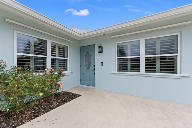 doorway to property with stucco siding