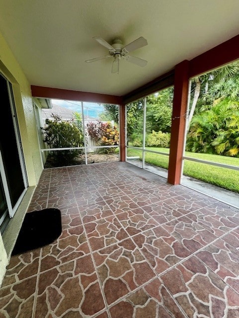 8036 105th Ct, Vero Beach, FL 32967 - unfurnished sunroom featuring stone flooring and ceiling fan