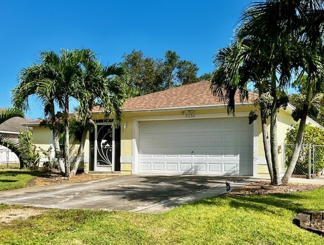 single story home with a front yard, roof with shingles, stucco siding, a garage, and driveway