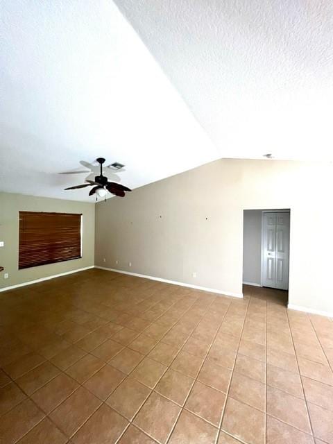 8036 105th Ct, Vero Beach, FL 32967 - unfurnished room with light tile patterned flooring, a ceiling fan, baseboards, vaulted ceiling, and a textured ceiling
