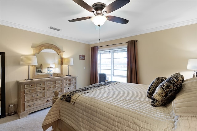 carpeted bedroom featuring ceiling fan and ornamental molding