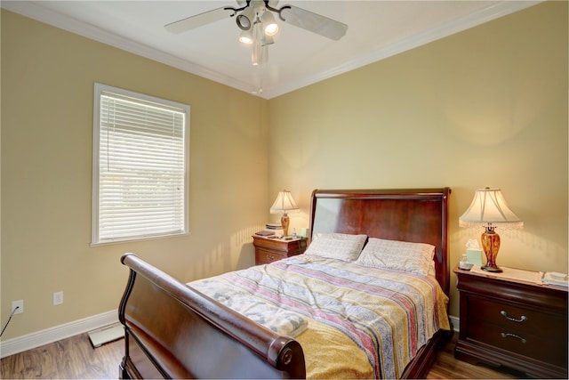 bedroom with hardwood / wood-style flooring, ceiling fan, and crown molding