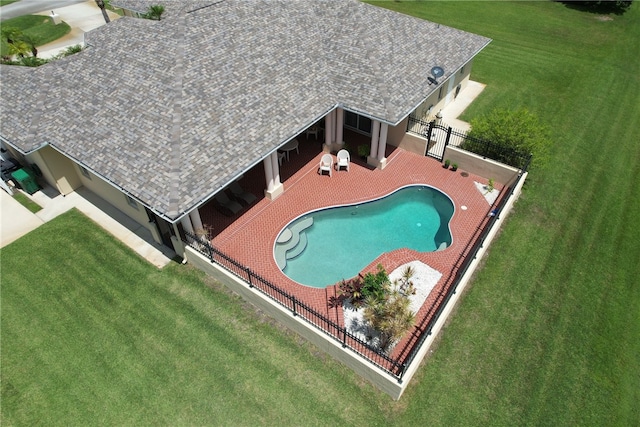 view of swimming pool with a lawn and a patio area