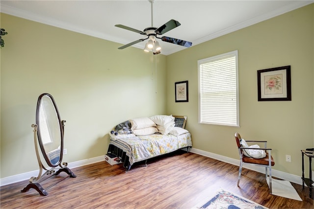 sitting room with ceiling fan, hardwood / wood-style floors, and ornamental molding