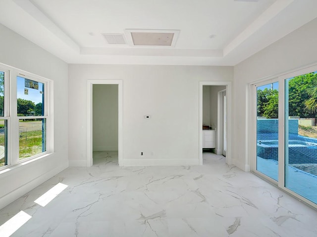 985 Clipper Rd, Vero Beach, FL 32963 - unfurnished room featuring a raised ceiling and light marble finish floors