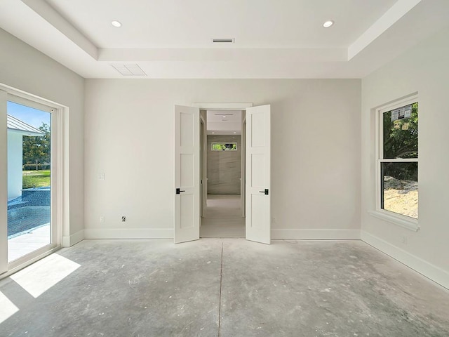 985 Clipper Rd, Vero Beach, FL 32963 - unfurnished room featuring a raised ceiling, recessed lighting, and concrete floors