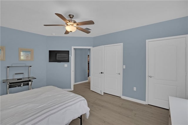 bedroom with ceiling fan and light hardwood / wood-style flooring