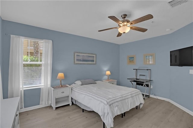 bedroom with light hardwood / wood-style floors and ceiling fan