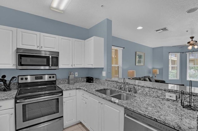 kitchen featuring appliances with stainless steel finishes, sink, and white cabinets