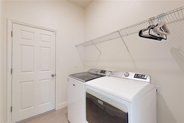 2545 Saint Lucia Cir, Vero Beach, FL 32967 - laundry room with washing machine and clothes dryer and baseboards