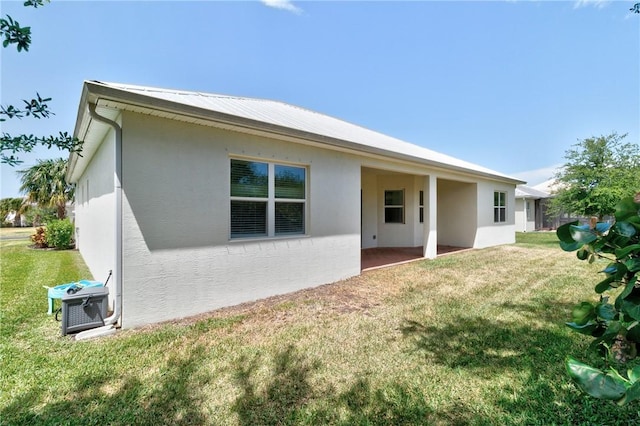 2545 Saint Lucia Cir, Vero Beach, FL 32967 - back of property featuring stucco siding, a yard, and a patio area