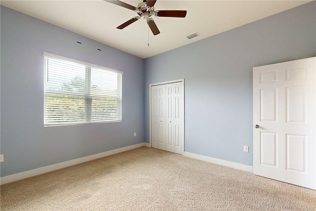 2545 Saint Lucia Cir, Vero Beach, FL 32967 - unfurnished bedroom with light carpet, a closet, and baseboards