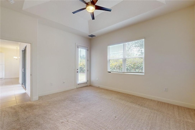 2545 Saint Lucia Cir, Vero Beach, FL 32967 - unfurnished room featuring light colored carpet, ceiling fan, baseboards, a chandelier, and a raised ceiling