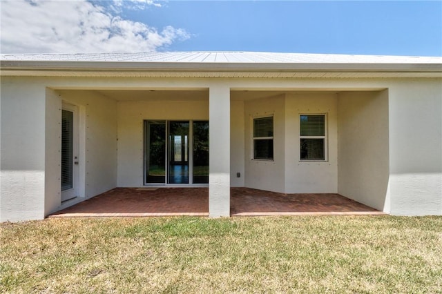 2545 Saint Lucia Cir, Vero Beach, FL 32967 - back of property featuring stucco siding, a patio area, and a lawn