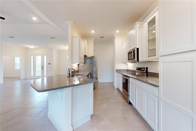 2545 Saint Lucia Cir, Vero Beach, FL 32967 - kitchen featuring stainless steel appliances, a sink, glass insert cabinets, white cabinets, and light tile patterned floors