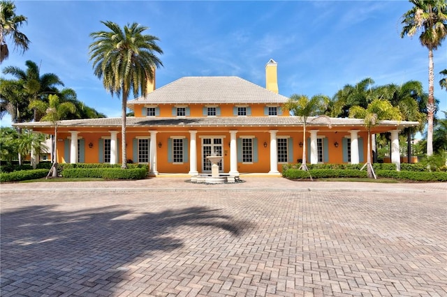2545 Saint Lucia Cir, Vero Beach, FL 32967 - view of front of house featuring a chimney, stucco siding, and a tile roof