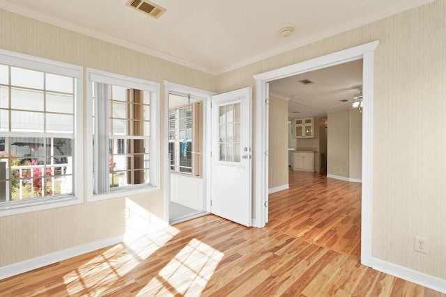 unfurnished sunroom featuring ceiling fan