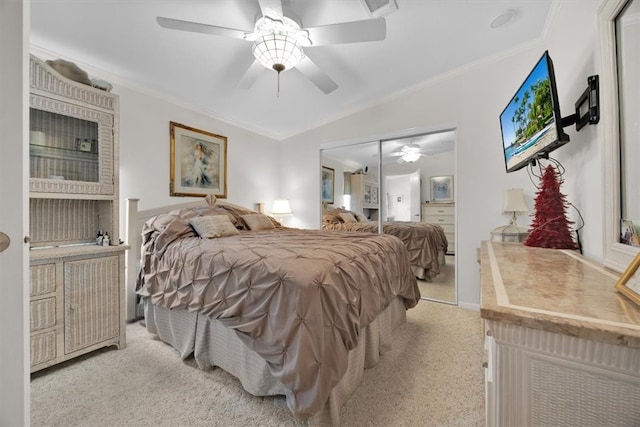 carpeted bedroom featuring ceiling fan, a closet, vaulted ceiling, and ornamental molding