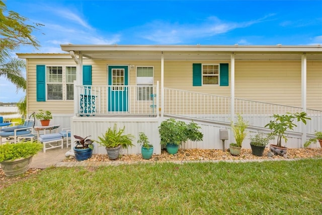 exterior space featuring covered porch and a front lawn