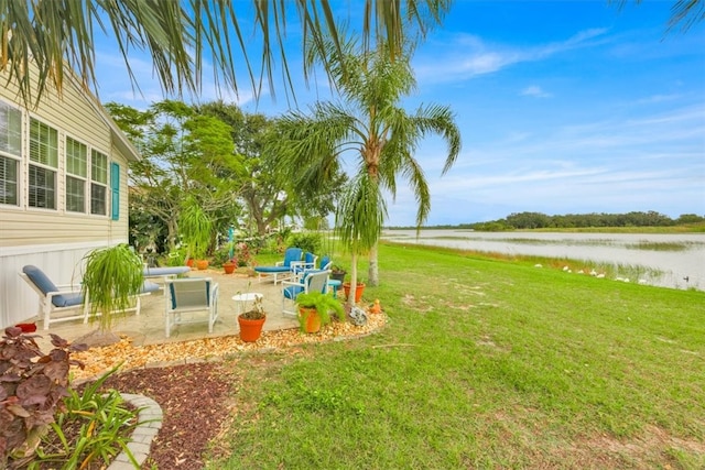 view of yard featuring a patio and a water view