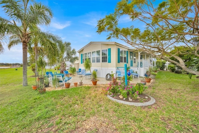 view of side of home featuring a yard and a patio