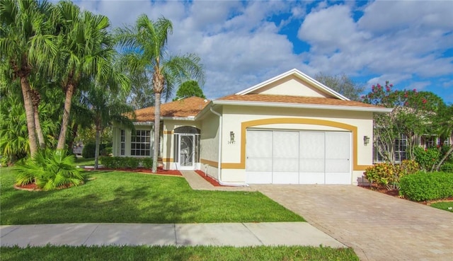 view of front of home with a front yard and a garage