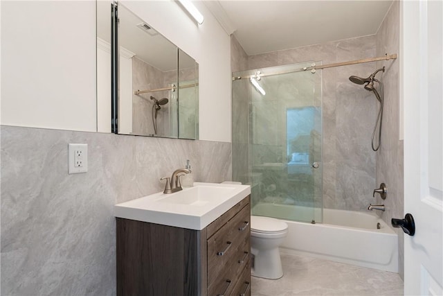 full bathroom with tile walls, combined bath / shower with glass door, toilet, decorative backsplash, and vanity